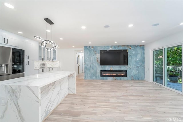 2143 Ronda Granada Unit P, Laguna Woods, CA 92637 - living room with light wood-style floors, recessed lighting, and a large fireplace
