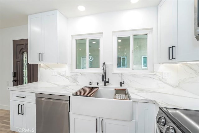 2143 Ronda Granada Unit P, Laguna Woods, CA 92637 - kitchen with appliances with stainless steel finishes, decorative backsplash, light stone counters, white cabinets, and recessed lighting