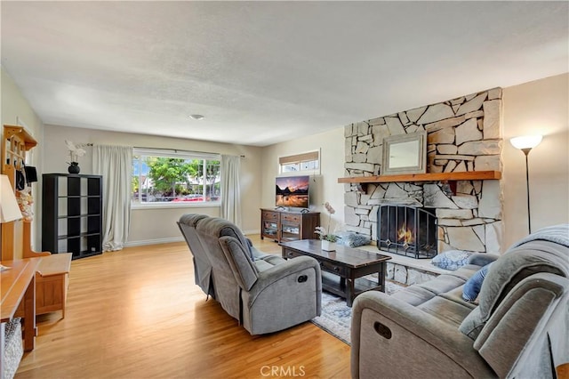 15041 Columbia Ln, Huntington Beach, CA 92647 - living room with light wood-style flooring and a stone fireplace
