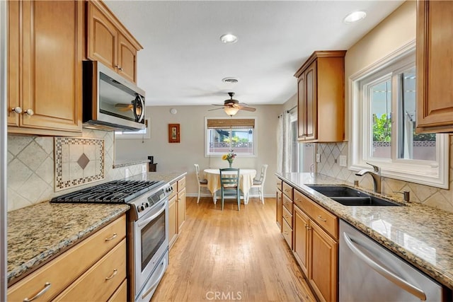 15041 Columbia Ln, Huntington Beach, CA 92647 - kitchen featuring stainless steel appliances, light wood-type flooring, backsplash, light stone counters, and recessed lighting