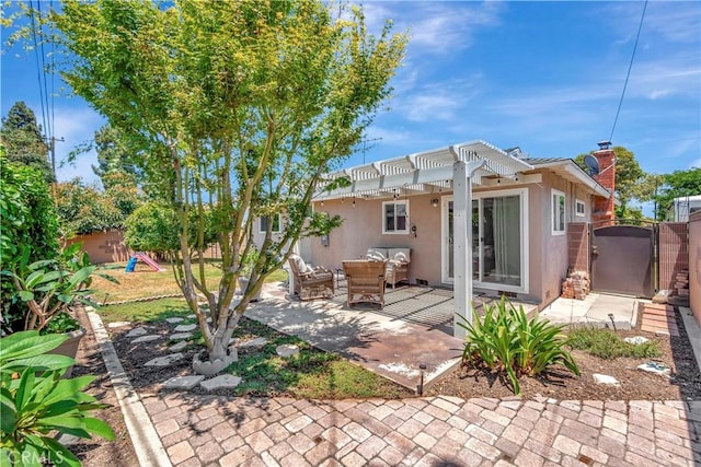 15041 Columbia Ln, Huntington Beach, CA 92647 - back of house featuring a gate, stucco siding, a pergola, a patio, and an outdoor hangout area