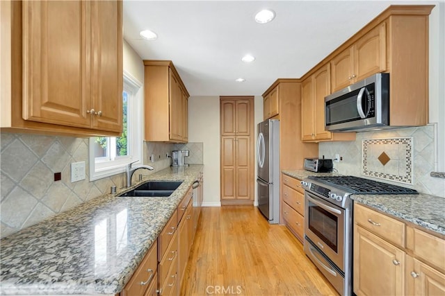 15041 Columbia Ln, Huntington Beach, CA 92647 - kitchen with stainless steel appliances, light wood-type flooring, light stone countertops, recessed lighting, and decorative backsplash