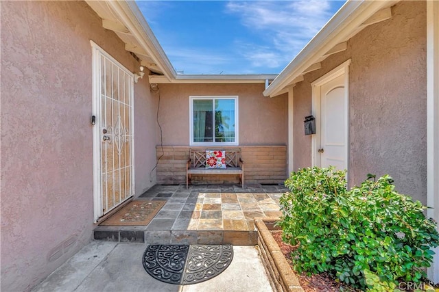 15041 Columbia Ln, Huntington Beach, CA 92647 - view of exterior entry featuring stucco siding and a patio area
