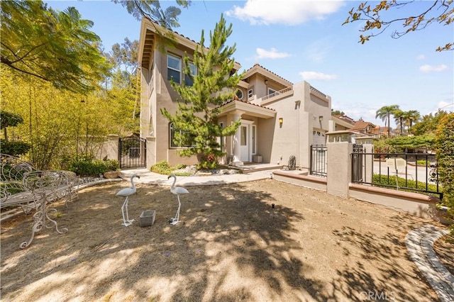 2767 Saleroso Dr, Rowland Heights, CA 91748 - back of property with a gate, stucco siding, a balcony, and a tile roof