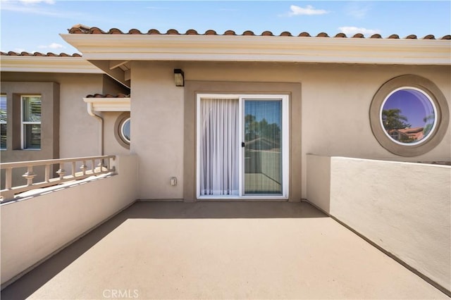 2767 Saleroso Dr, Rowland Heights, CA 91748 - view of exterior entry with stucco siding, a tile roof, and a patio area