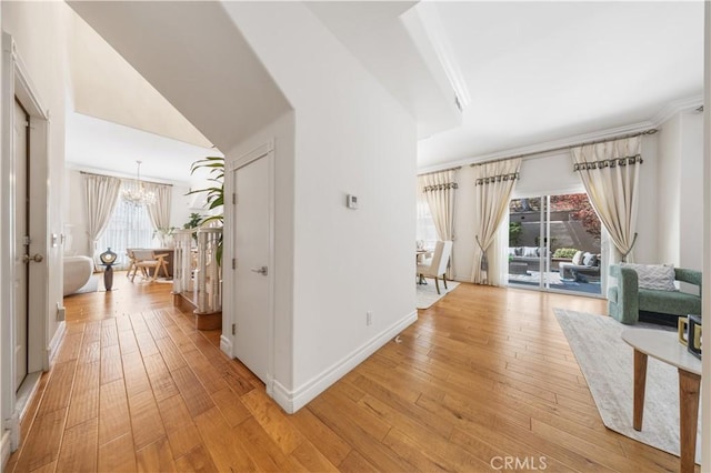 2767 Saleroso Dr, Rowland Heights, CA 91748 - corridor featuring a chandelier, light wood finished floors, and arched walkways