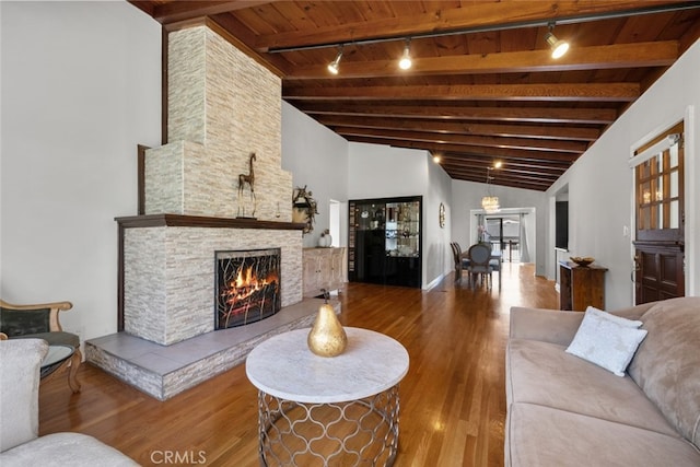 2920 Fairmount Ave, La Crescenta, CA 91214 - living room featuring wooden ceiling, rail lighting, wood finished floors, and a stone fireplace