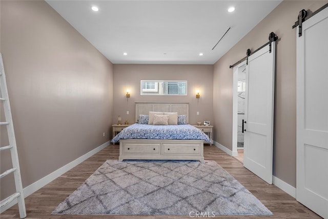 2920 Fairmount Ave, La Crescenta, CA 91214 - bedroom featuring a barn door, light wood-type flooring, and recessed lighting