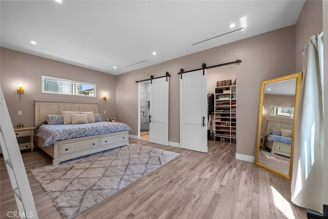 2920 Fairmount Ave, La Crescenta, CA 91214 - bedroom featuring a barn door, a spacious closet, light wood-style floors, and recessed lighting