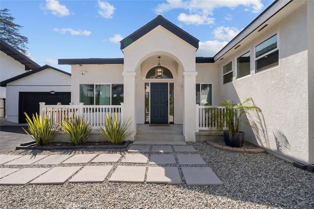 2920 Fairmount Ave, La Crescenta, CA 91214 - doorway to property featuring stucco siding, a garage, and a porch
