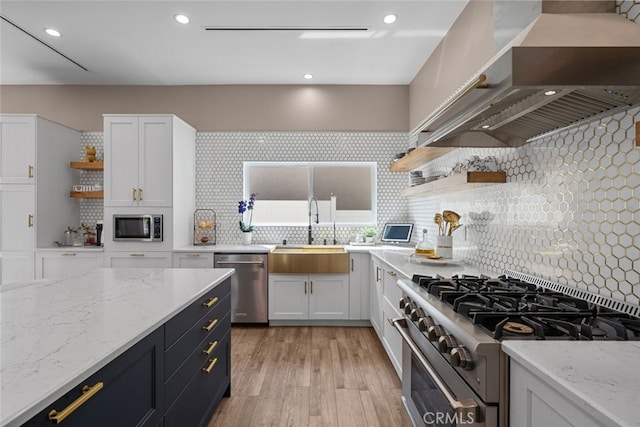2920 Fairmount Ave, La Crescenta, CA 91214 - kitchen with open shelves, stainless steel appliances, wall chimney range hood, white cabinetry, and recessed lighting
