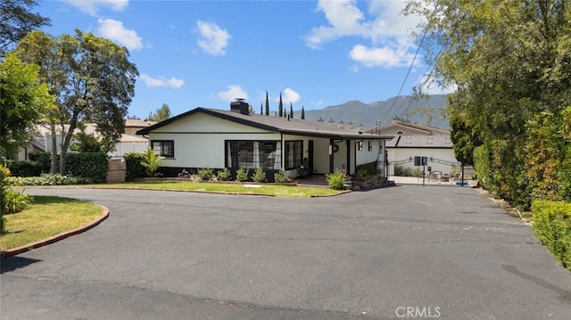 2920 Fairmount Ave, La Crescenta, CA 91214 - ranch-style home featuring a mountain view, asphalt driveway, stucco siding, and a gate