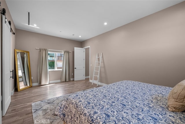 2920 Fairmount Ave, La Crescenta, CA 91214 - bedroom with a barn door, wood finished floors, and recessed lighting