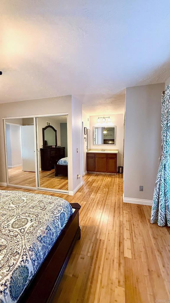 14330 Jennings Vista Way, Lakeside, CA 92040 - bedroom with light wood-style floors, connected bathroom, and a closet