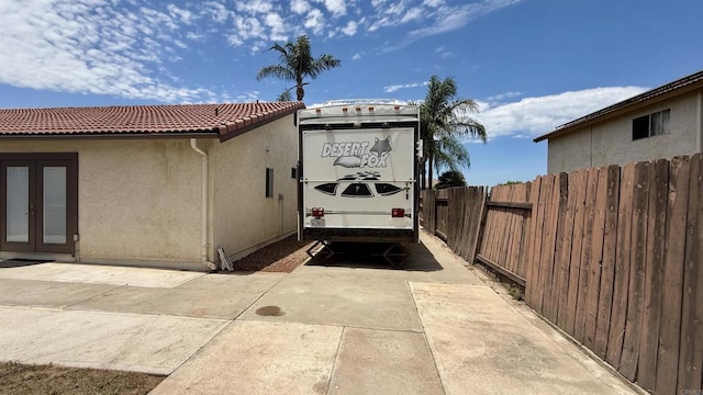 14330 Jennings Vista Way, Lakeside, CA 92040 - view of property exterior featuring a tiled roof, french doors, stucco siding, and a patio area
