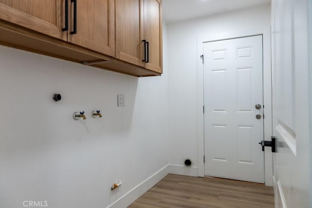 8666 Calaveras Ave, Rancho Cucamonga, CA 91730 - laundry room featuring cabinet space, light wood-type flooring, and hookup for an electric dryer