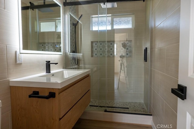 8666 Calaveras Ave, Rancho Cucamonga, CA 91730 - full bathroom featuring vanity, a shower stall, tile walls, and decorative backsplash