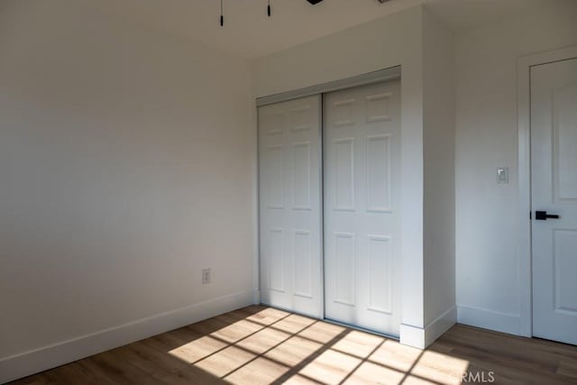 8666 Calaveras Ave, Rancho Cucamonga, CA 91730 - unfurnished bedroom featuring wood finished floors and a closet
