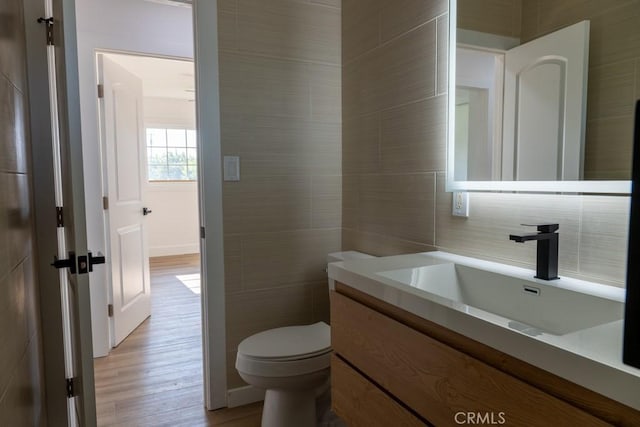 8666 Calaveras Ave, Rancho Cucamonga, CA 91730 - bathroom featuring tile walls, vanity, and wood finished floors