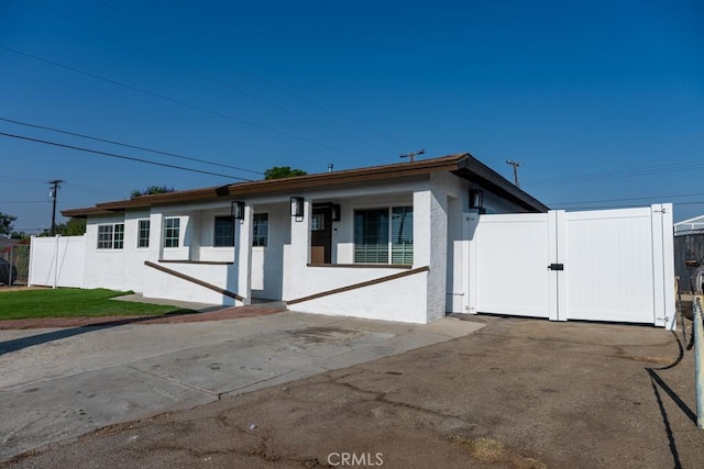 8666 Calaveras Ave, Rancho Cucamonga, CA 91730 - view of front facade featuring stucco siding and a gate
