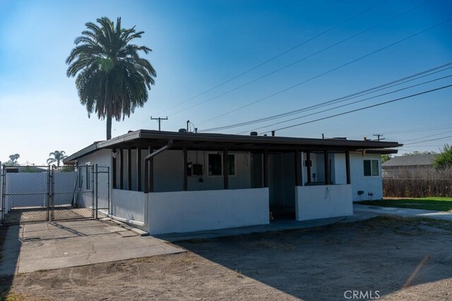 8666 Calaveras Ave, Rancho Cucamonga, CA 91730 - view of front of house with a gate and stucco siding