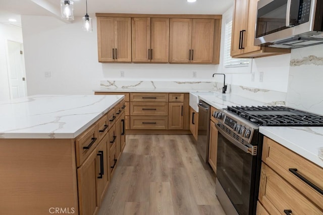 8666 Calaveras Ave, Rancho Cucamonga, CA 91730 - kitchen featuring stainless steel appliances, light wood finished floors, light stone counters, decorative light fixtures, and recessed lighting