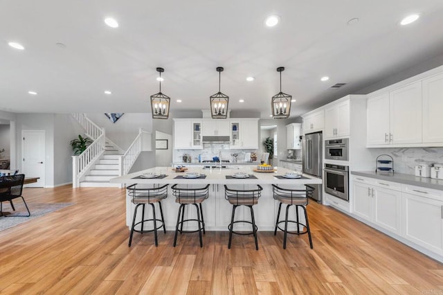 2990Eldenberry St, Escondido, CA 92029 - kitchen with stainless steel appliances, a kitchen bar, backsplash, and recessed lighting