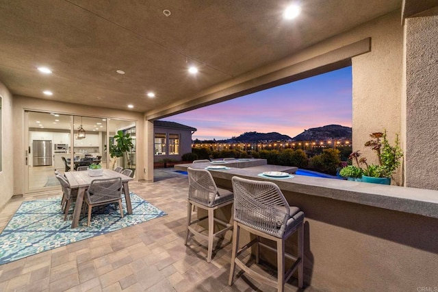 2990Eldenberry St, Escondido, CA 92029 - patio terrace at dusk featuring an in-ground hot tub, a patio area, and outdoor dining area