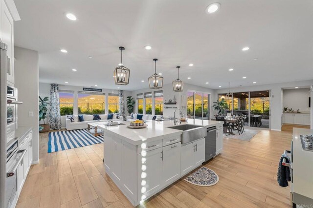 2990Eldenberry St, Escondido, CA 92029 - kitchen featuring open floor plan, appliances with stainless steel finishes, recessed lighting, white cabinetry, and a kitchen island with sink