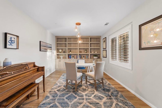 2990Eldenberry St, Escondido, CA 92029 - dining space with light wood finished floors, built in shelves, and a desk