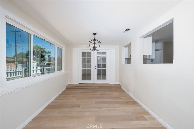 880 E Wright St, Hemet, CA 92543 - hallway featuring light wood-style floors, french doors, and a chandelier