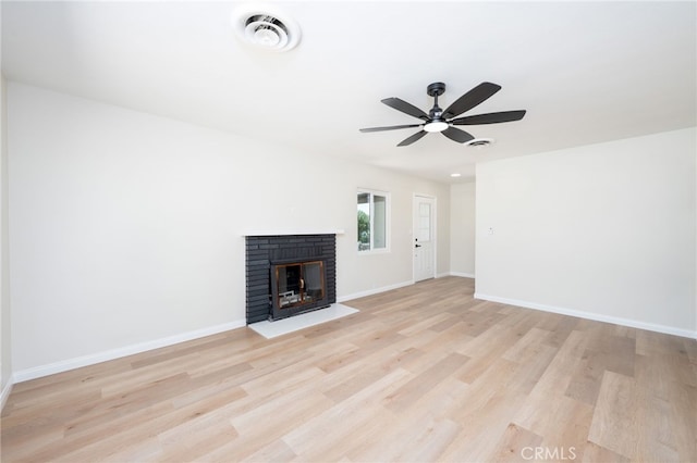 880 E Wright St, Hemet, CA 92543 - unfurnished living room with light wood finished floors, a ceiling fan, and a brick fireplace