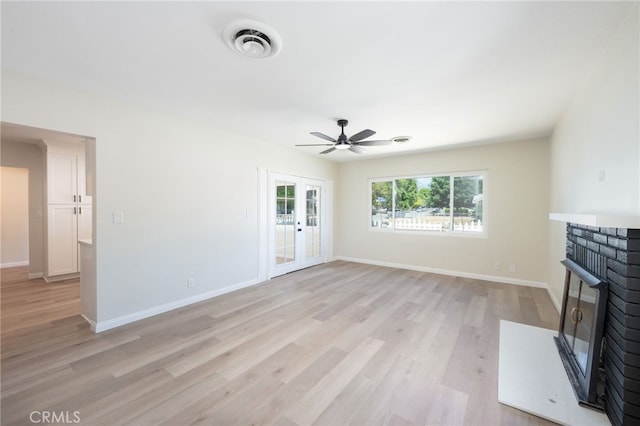 880 E Wright St, Hemet, CA 92543 - unfurnished living room featuring light wood-style floors, ceiling fan, french doors, and a fireplace
