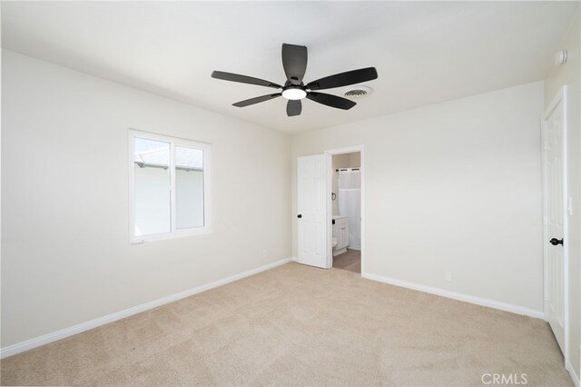 880 E Wright St, Hemet, CA 92543 - unfurnished bedroom with light colored carpet, ensuite bathroom, and ceiling fan