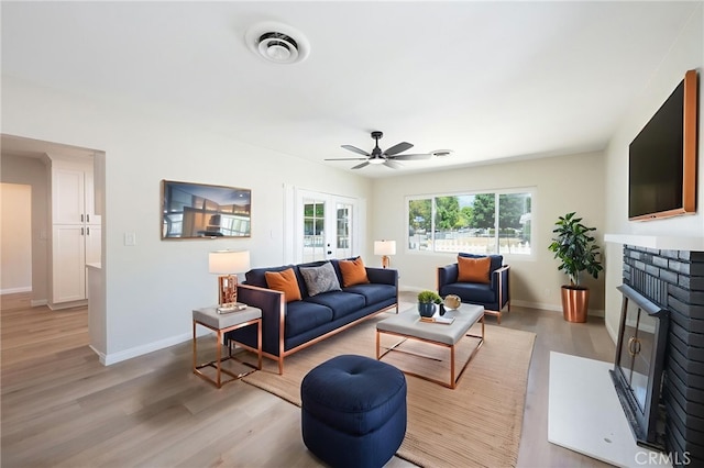 880 E Wright St, Hemet, CA 92543 - living area featuring light wood finished floors, a brick fireplace, and a ceiling fan