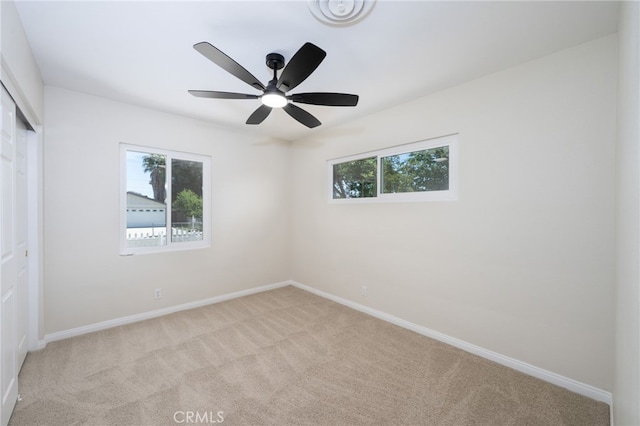 880 E Wright St, Hemet, CA 92543 - unfurnished bedroom featuring carpet flooring, multiple windows, a closet, and ceiling fan
