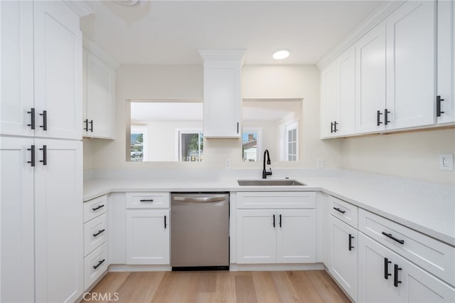 880 E Wright St, Hemet, CA 92543 - kitchen with stainless steel dishwasher, light countertops, light wood-type flooring, and white cabinets