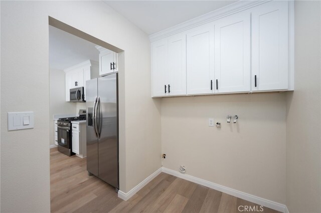 880 E Wright St, Hemet, CA 92543 - laundry room featuring light wood-style floors, cabinet space, and gas dryer hookup