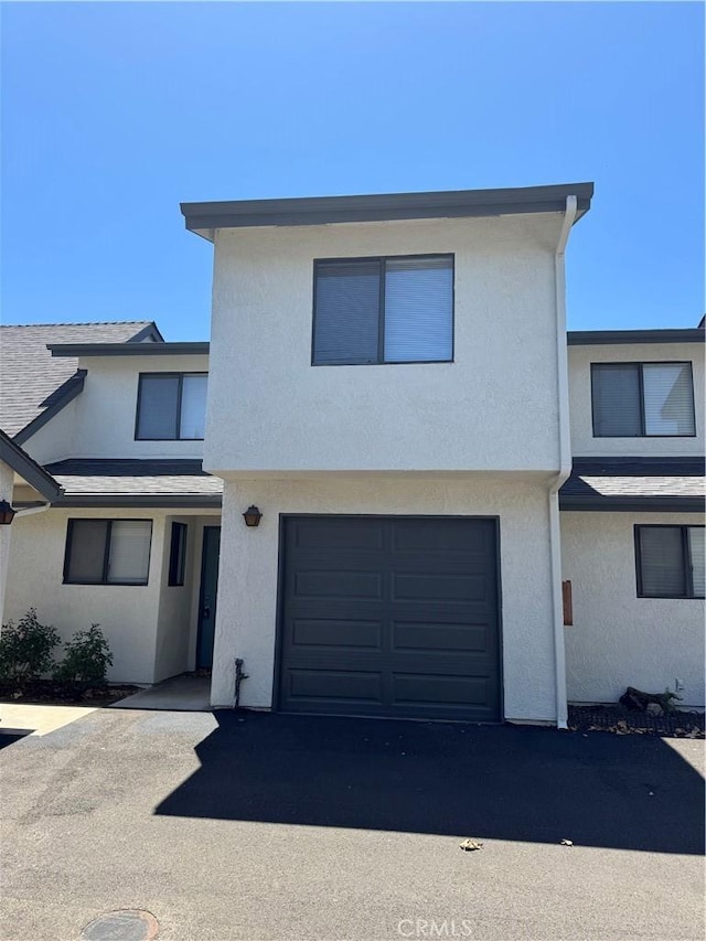10710 El Camino Real Unit 14, Atascadero, CA 93422 - townhome / multi-family property with a garage, stucco siding, and asphalt driveway
