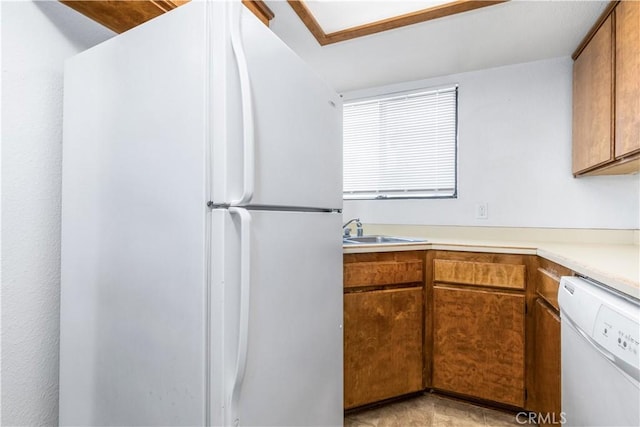 10710 El Camino Real Unit 14, Atascadero, CA 93422 - kitchen with white appliances, brown cabinetry, and light countertops