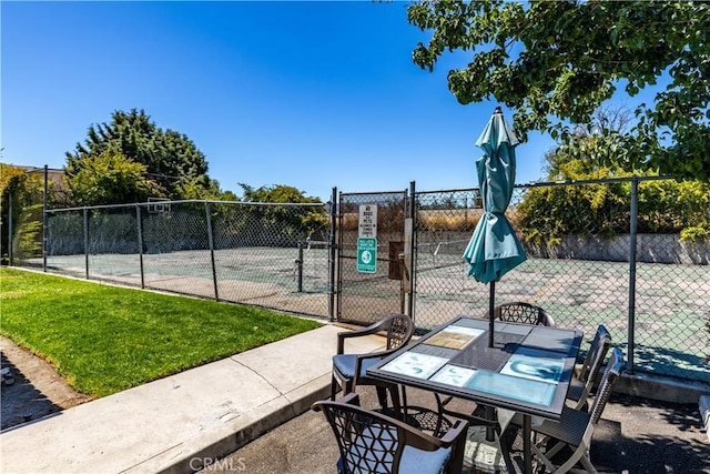 10710 El Camino Real Unit 14, Atascadero, CA 93422 - view of tennis court featuring a gate and outdoor dining space