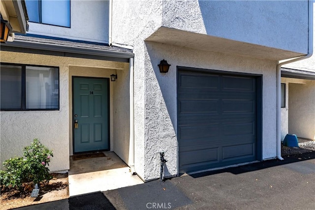 10710 El Camino Real Unit 14, Atascadero, CA 93422 - doorway to property with stucco siding and a garage