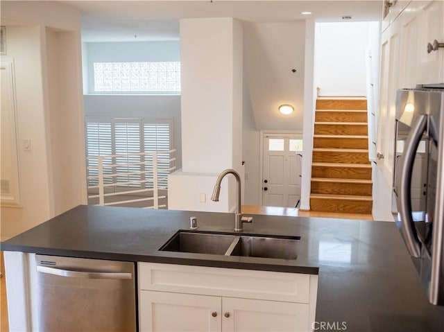 1628 E Palm Ave Unit 5, El Segundo, CA 90245 - kitchen featuring stainless steel dishwasher, fridge, dark countertops, white cabinets, and a high ceiling