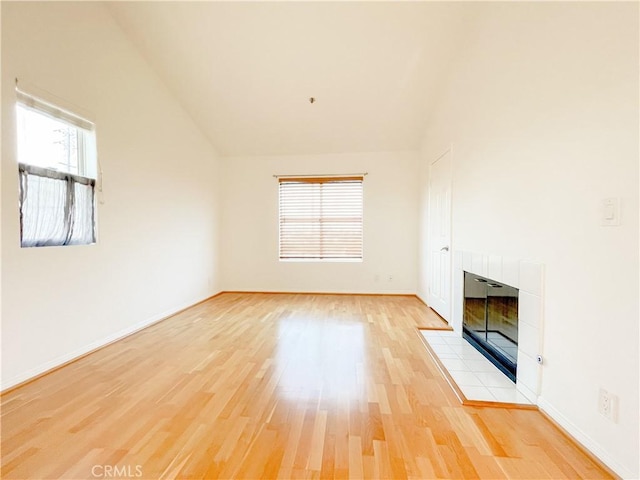 1628 E Palm Ave Unit 5, El Segundo, CA 90245 - unfurnished living room featuring a fireplace, light wood-style floors, and vaulted ceiling