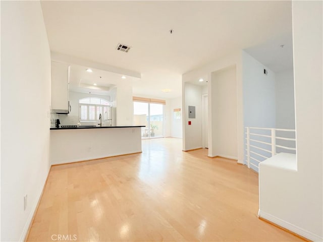 1628 E Palm Ave Unit 5, El Segundo, CA 90245 - unfurnished living room featuring light wood-style flooring and recessed lighting