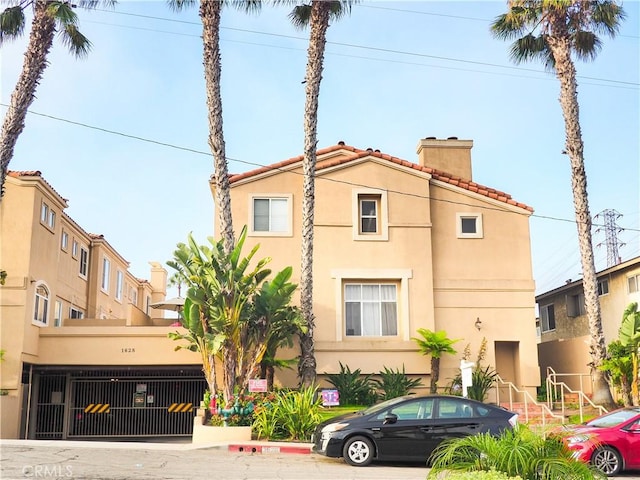 1628 E Palm Ave Unit 5, El Segundo, CA 90245 - view of front facade with a chimney, stucco siding, and a tile roof