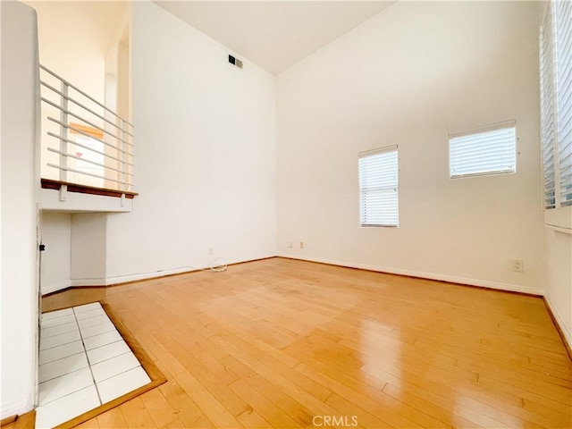 1628 E Palm Ave Unit 5, El Segundo, CA 90245 - empty room featuring high vaulted ceiling and hardwood / wood-style floors