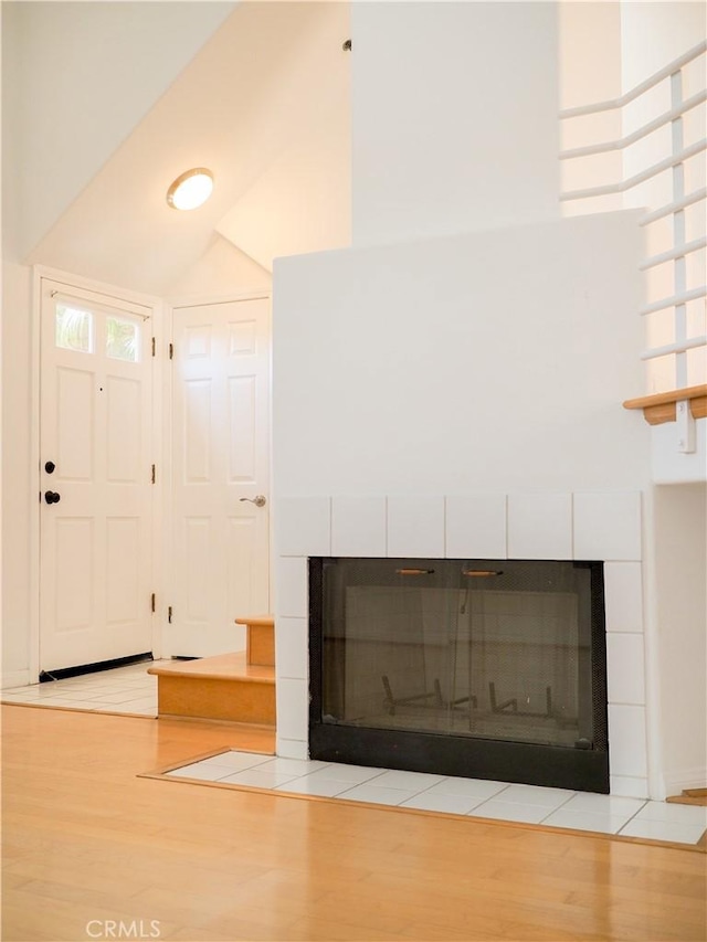 1628 E Palm Ave Unit 5, El Segundo, CA 90245 - foyer entrance with a fireplace, light wood finished floors, and a towering ceiling