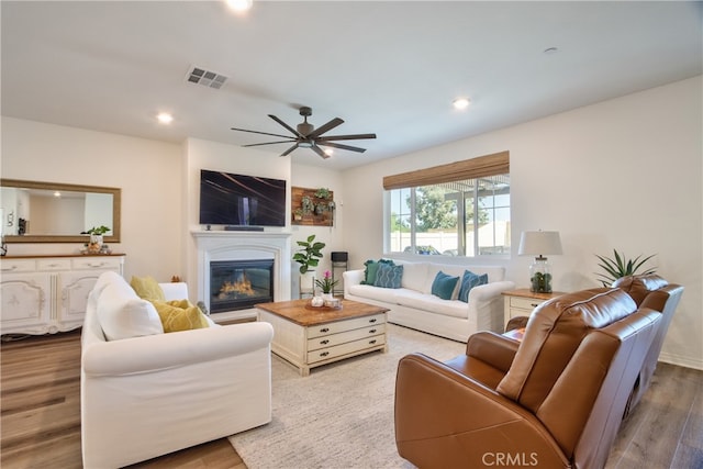 33084 Toledo Bend Ct, Winchester, CA 92596 - living room with ceiling fan, a glass covered fireplace, wood finished floors, and recessed lighting