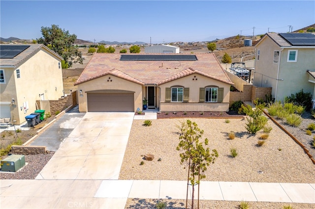 33084 Toledo Bend Ct, Winchester, CA 92596 - mediterranean / spanish-style house with a tile roof, an attached garage, stucco siding, solar panels, and driveway